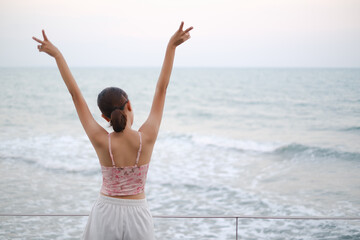 young asia woman stand resting on tropical Beach, travel the sea