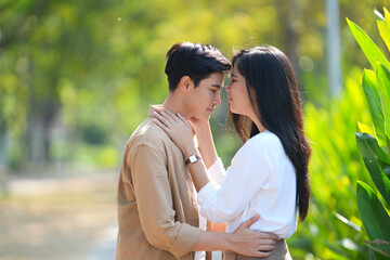 Fototapeta premium Beautiful young couple outdoors in the park. Portraits of lovers. Autumn. Spring. Holiday Valentine's Day.