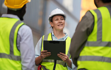 Foreman control loading containers box from cargo freight ship for import export, Foreman control industrial container cargo freight ship, Business logistic concept, Import and export concept