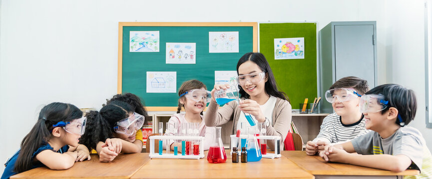Diversity children student doing a chemical experiment in laboratory at school. Portrait of happy kids at elementary school learn science chemistry with asian teacher. Fun study back to school banner
