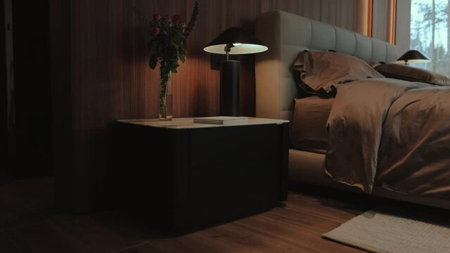 Room in house with hardwood flooring, bed, nightstand, lamp, window