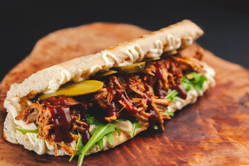 pulled pork sandwich with cucumber and arugula
