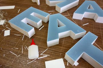 Three-dimensional light letters made of plastic. Production of a logo for the store.