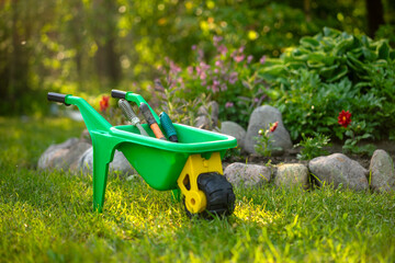 A children's garden cart.Helping mom in the garden. Family work in the garden.