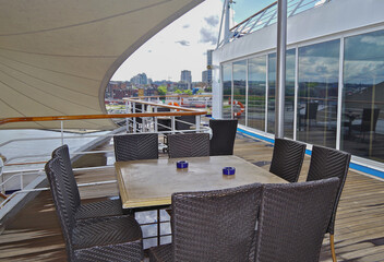 Deck chairs and sun loungers on outdoor swimmingpool pool deck with panoramic ocean views on modern luxury Italian cruiseship cruise ship liner