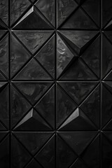 Overhead view of textured black tiles in a geometric arrangement.