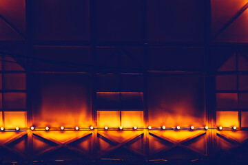 Dark draped decorated wall with red orange backlight