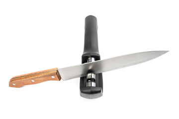 knife with sharpener on the table. Knife and knife sharpener on a white surface. Kitchen tools isolated on white background. Reversible manual knife sharpener.	