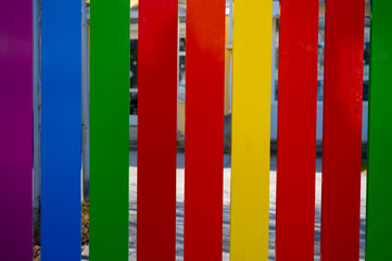 Multicolored vertical planks iron fence in kindergarten