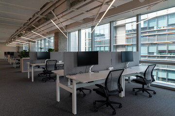 Interior of modern empty office building.Open ceiling design.Equipped with automatic lifting table and LCD screen.