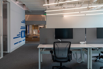 Interior of modern empty office building.Open ceiling design.Equipped with automatic lifting table and LCD screen.