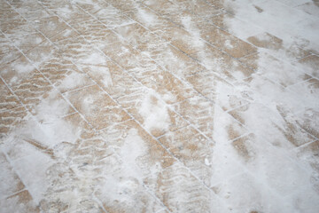 Snow on the road. Snow texture. Marked tracks.