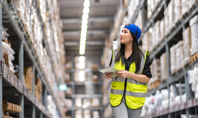 Female engineer is handling shipping and checking stock inventory in the warehouse with a tablet, industry, import-export, inventory management, logistics, global transportation at warehouse, business © Art_Photo