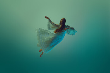 Woman in stunning dress, gracefully suspend in mid-air, conveys sense of fluidity and grace against...
