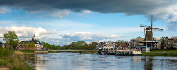 Panorama of Ommen, Province Overijssel. View of the Vechte river and the historical dutch windmill...