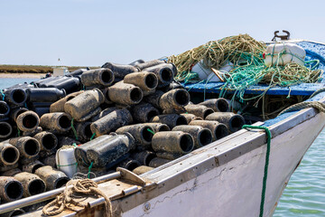 Santa Luzia, Portugal 04-16-2024. Boat withe Container used to catch octopuses in the fishing port...