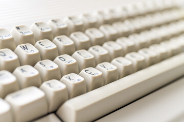 Close-up of vintage Commodore 64 keyboard with cream-colored keys and letters. Daylight...