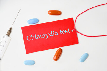 Medical concept. Chlamydia Test text on a red card with a rope on a white background