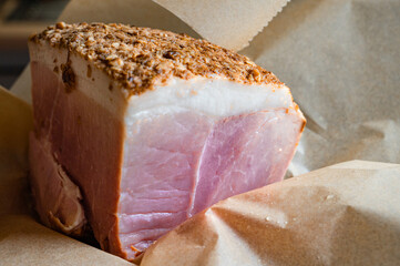 boiled smoked ham in spices and paper, home cooking