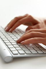 Close-up of hands on a keyboard of a desktop computer or laptop being used by an office worker while working in a corporate business workplace, stock illustration image