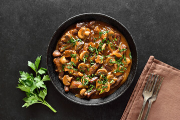 Beef stroganoff with mushrooms in frying pan