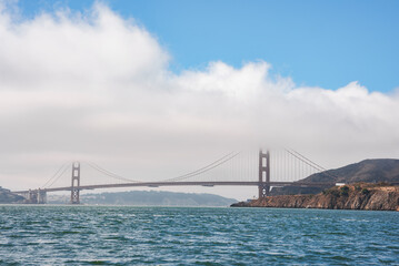 Daytime view of the Golden Gate Bridge in San Francisco, CA. Iconic orange bridge against blue sky,...