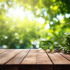 Empty wooden tabletop with a blurred summer background and a branch with green leaves lying on it.