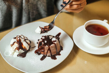 Dessert on a White Plate With a Cup of Tea