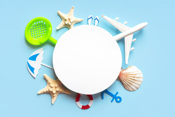 Flat lay composition with starfish, seashells, beach accessories and plane with round blank with...