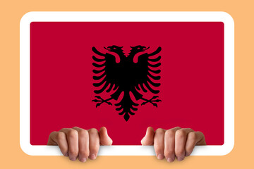 Hands holding a white frame with Albania flag, two hands and frame, independence day idea, protest 