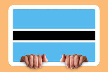 Hands holding a white frame with Botswana flag, two hands and frame, protest or social issues in 