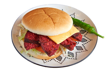 Beef burger on decorated plate on wooden textured table