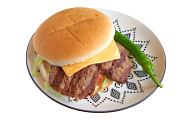 Pork burger on decorated plate on wooden textured table