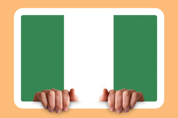 Hands holding a white frame with Nigeria flag, two hands and frame, celebration or campaigning 