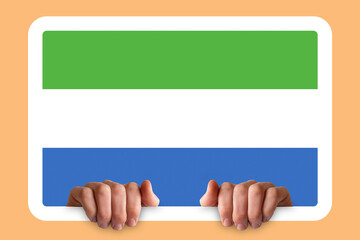 Hands holding a white frame with Sierra Leone flag, celebration or campaigning concept, two hands 