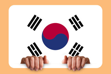 Hands holding a white frame with South Korea flag, protest or social issues in South Korea