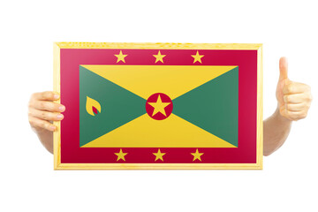Hands holding a frame with Grenada flag, independence day idea, approvement or success in Grenada