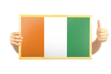 Hands holding a frame with Ivory Coast flag, approvement or success in Ivory Coast, two hands and 