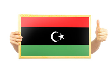 Hands holding a frame with Libya flag, approvement or success in Libya, independence day idea