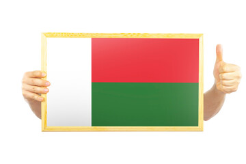 Hands holding a frame with Madagascar flag, independence day idea, celebration or victory concept