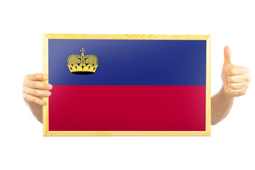 Hands holding a frame with Liechtenstein flag, two hands and thumb up, independence day idea