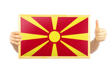 Hands holding a frame with Macedonia flag, independence day idea, celebration or victory concept