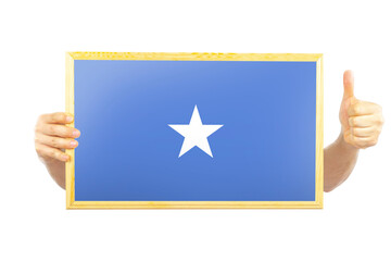 Hands holding a frame with Somalia flag, two hands and thumb up, independence day idea, approvement 