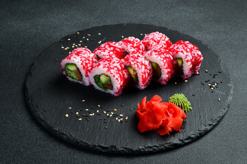 Sushi roll with caviar, salmon and avocado. Asian cuisine. Close up. Free space for your text.
