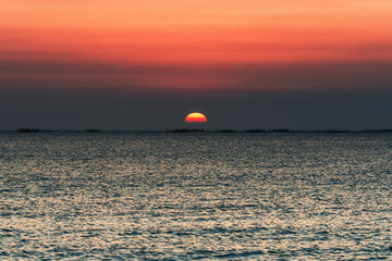 Sunset over the sea background. Big sun over the sea with beautiful natural light at sunset or sunrise.