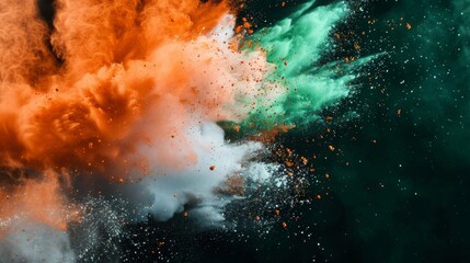 Colored powder explosion. Green, white and orange colors dust on black background. Multicolored powder splash background