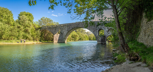 Sauve, France - 04 16 2024: Panoramic View of the Old Bridge Gate and the Vidourle river from the...