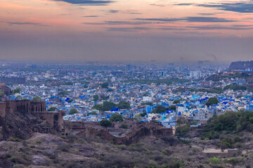 blue city view with dramatic sunset sky at evening from flat angle