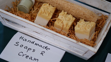 Handmade soaps and cream in a wooden box.