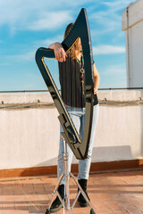 Hungarian harpist with an electronic harp making ancient music
